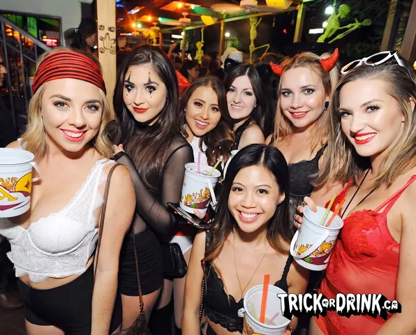 A group in Halloween costumes with drinks on the night